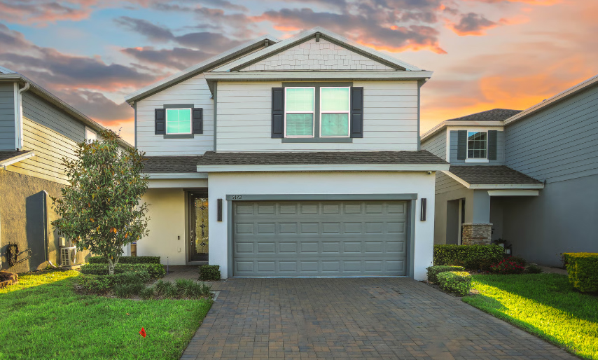 A beautiful modern two-story suburban home at sunset, representing the American dream for medical professionals.